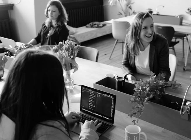 A picture of three woman happily working 